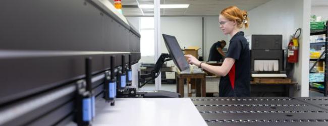 Two employees discussing a printing job